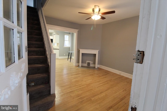 unfurnished living room featuring light hardwood / wood-style floors and ceiling fan