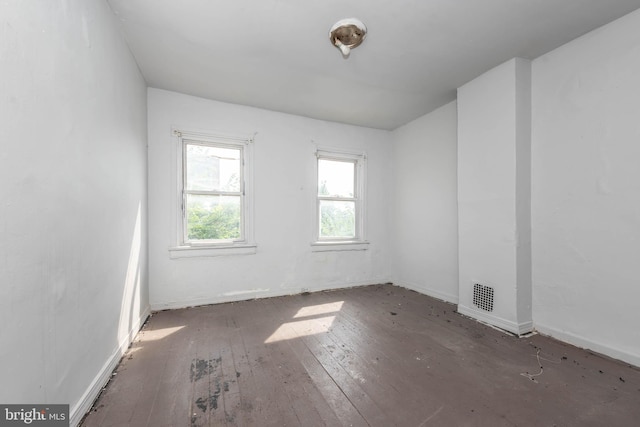 spare room with dark wood-type flooring