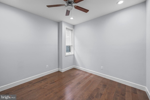 unfurnished room featuring ceiling fan and dark hardwood / wood-style flooring