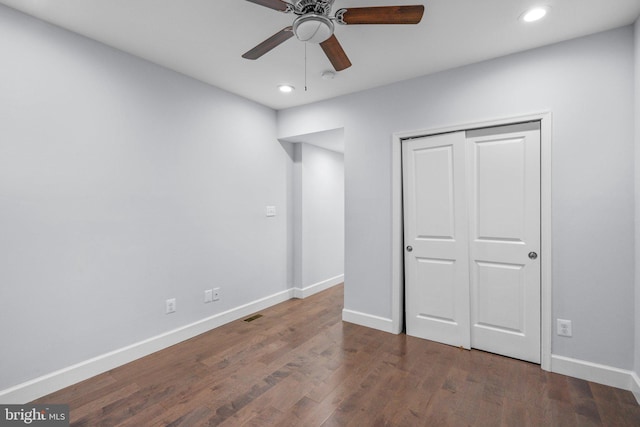 unfurnished bedroom with a closet, ceiling fan, and dark hardwood / wood-style flooring