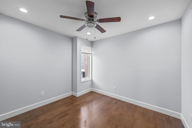 empty room with dark hardwood / wood-style floors and ceiling fan