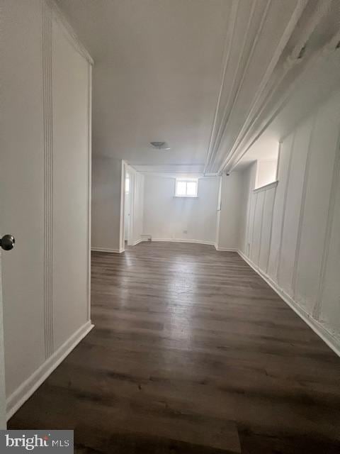 basement with dark hardwood / wood-style floors