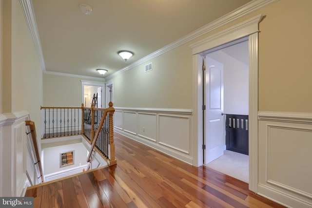 hall featuring ornamental molding and hardwood / wood-style flooring