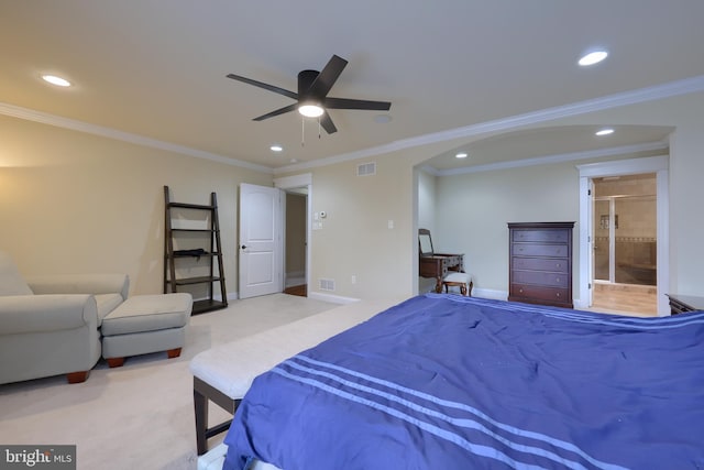 carpeted bedroom featuring ceiling fan, ensuite bathroom, and ornamental molding