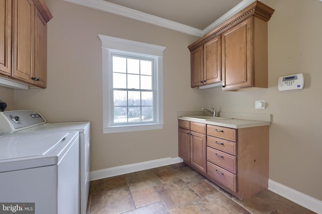 laundry area featuring sink, independent washer and dryer, crown molding, and cabinets