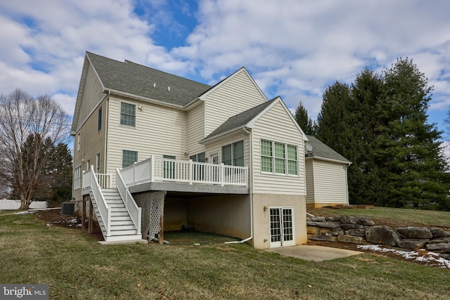 back of house with a wooden deck, a lawn, french doors, and central AC