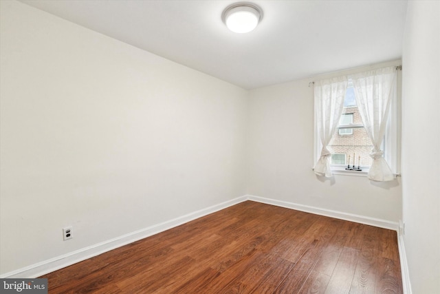 unfurnished room with wood-type flooring