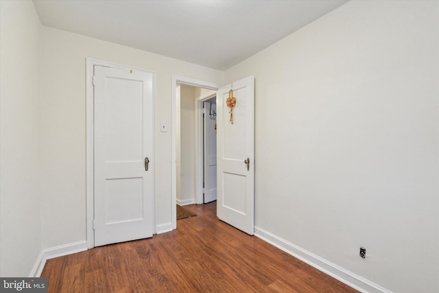 spare room with wood-type flooring