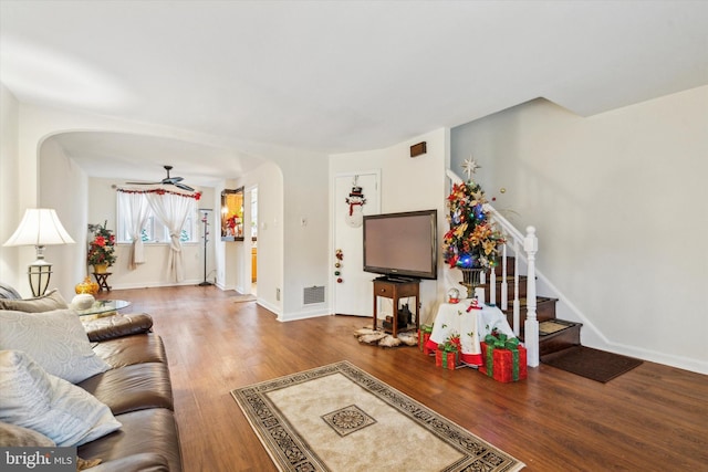 living room featuring hardwood / wood-style floors and ceiling fan