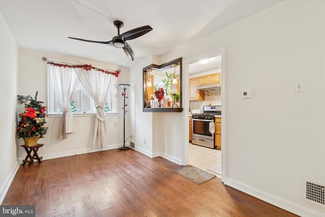 interior space with ceiling fan and hardwood / wood-style floors