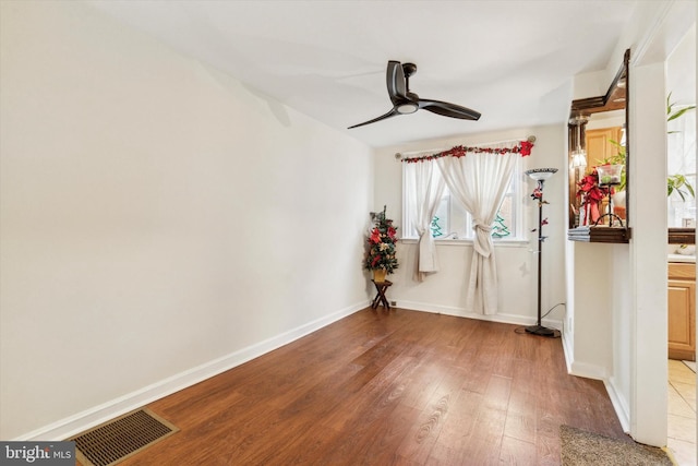 unfurnished room with ceiling fan and light wood-type flooring