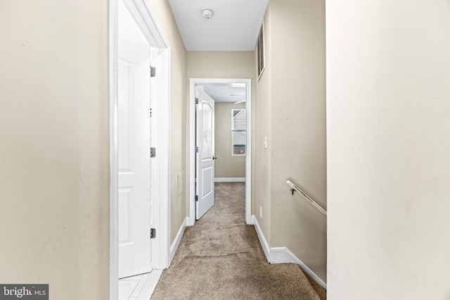 hallway featuring light carpet