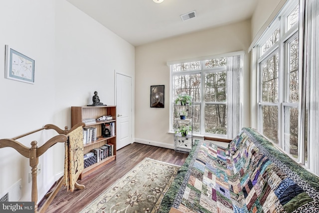 sitting room with dark wood-type flooring