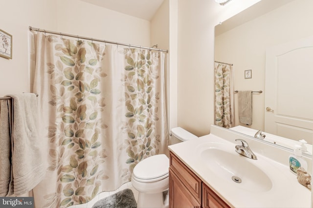 bathroom featuring walk in shower, vanity, and toilet