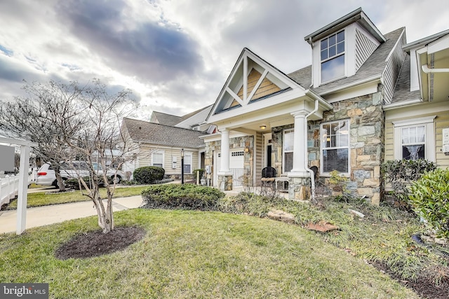 view of front of home with a front yard and a garage