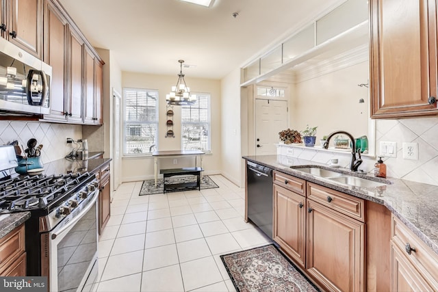 kitchen with stainless steel appliances, sink, light tile patterned floors, decorative light fixtures, and a chandelier