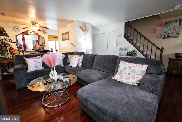 living room with ceiling fan and dark wood-type flooring