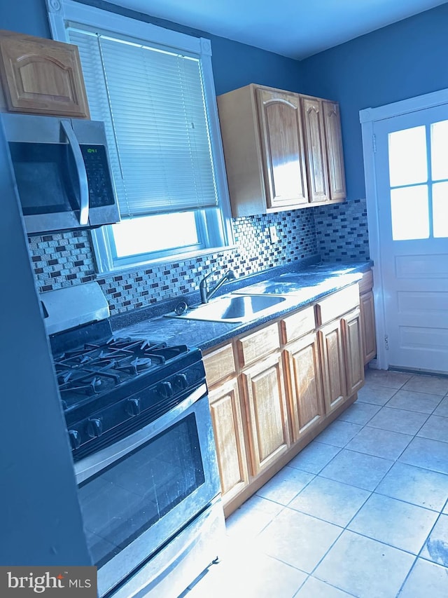 kitchen featuring backsplash, appliances with stainless steel finishes, sink, and light brown cabinetry