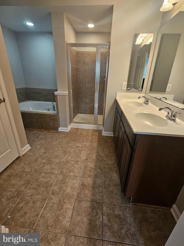 bathroom featuring tile patterned flooring, vanity, and plus walk in shower