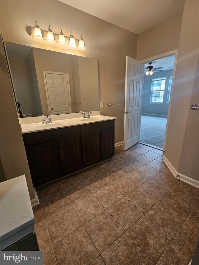 bathroom featuring tile patterned floors, ceiling fan, and vanity