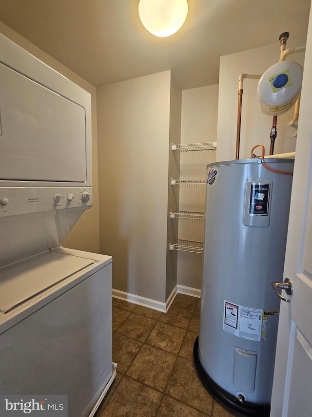 clothes washing area with electric water heater and stacked washer / drying machine