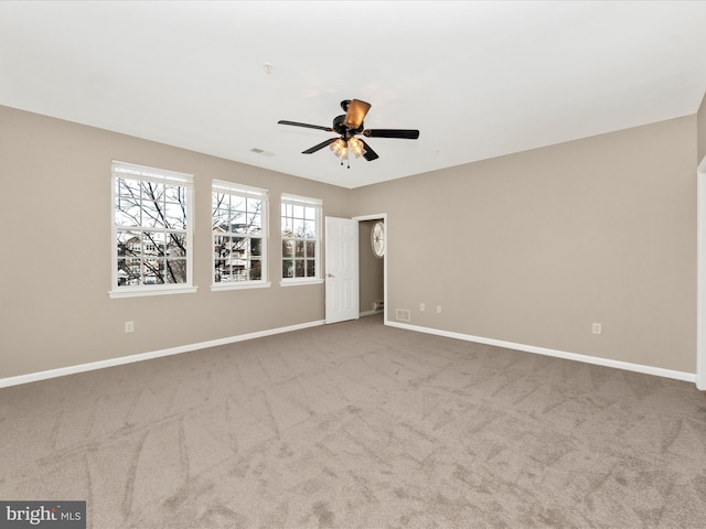 unfurnished room with ceiling fan and light colored carpet