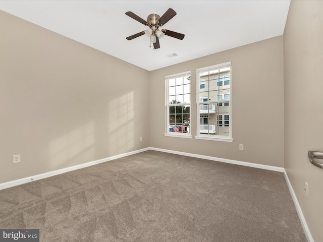 carpeted spare room with ceiling fan