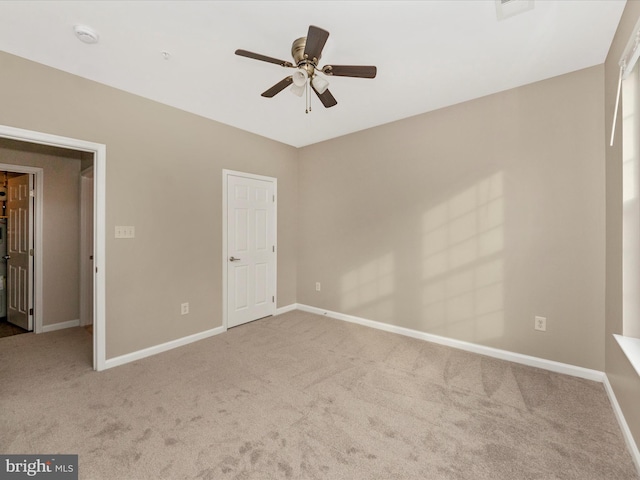 unfurnished bedroom featuring ceiling fan and light colored carpet