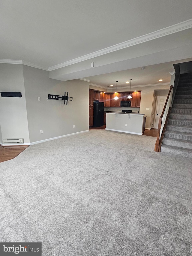 unfurnished living room featuring light colored carpet and ornamental molding