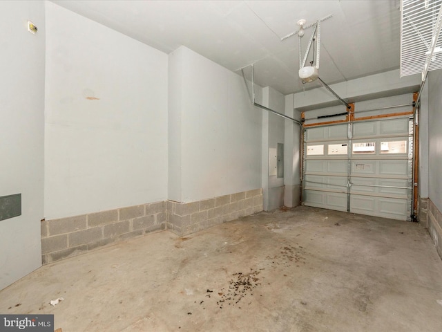 garage featuring electric panel and a garage door opener