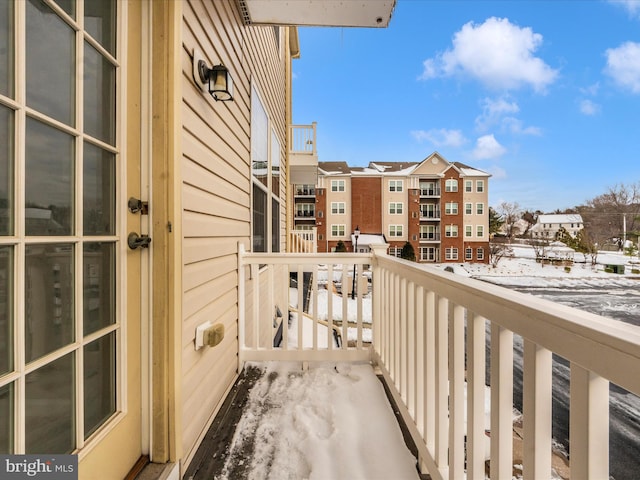 view of snow covered back of property