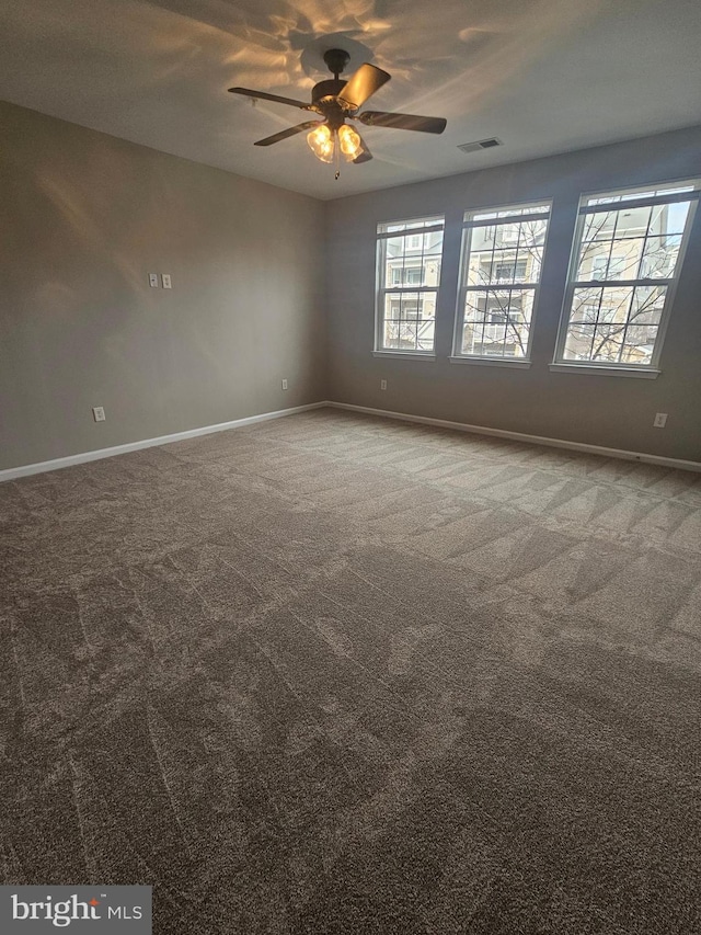 carpeted spare room with ceiling fan