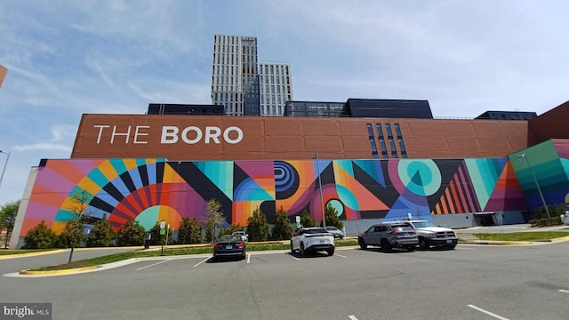 view of building exterior featuring uncovered parking