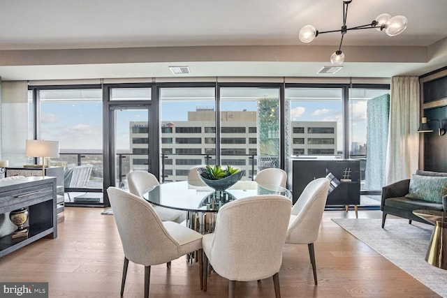 dining area featuring hardwood / wood-style flooring and a healthy amount of sunlight