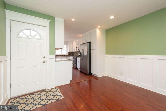 foyer entrance featuring dark hardwood / wood-style floors