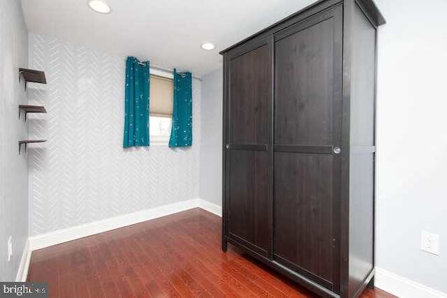 hall with dark hardwood / wood-style flooring