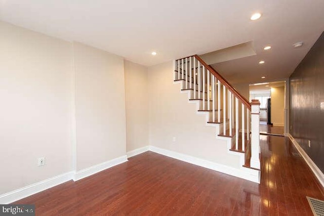 stairway featuring hardwood / wood-style flooring