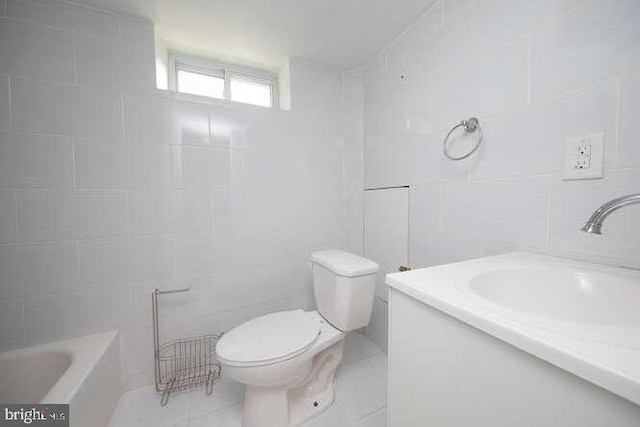 bathroom featuring vanity, toilet, tile walls, and a washtub