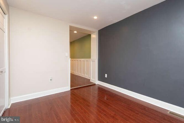 unfurnished room featuring dark wood-type flooring