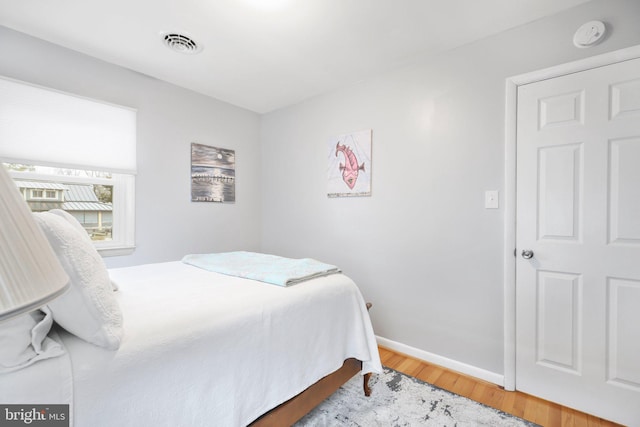 bedroom with hardwood / wood-style floors