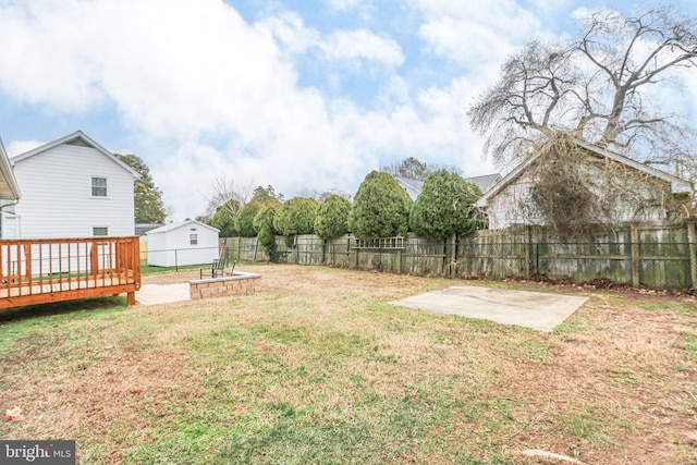 view of yard with a wooden deck and a patio area