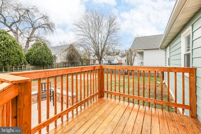 wooden deck featuring a lawn