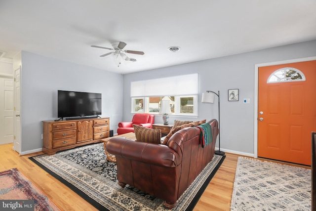 living room featuring ceiling fan and wood-type flooring