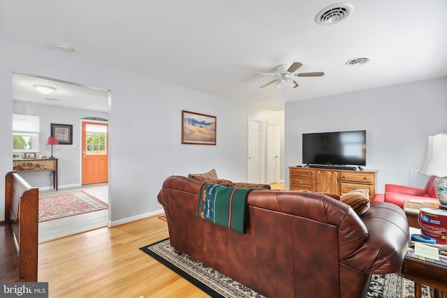 living room featuring light wood-type flooring and ceiling fan