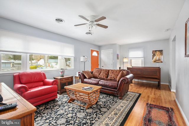 living room with light hardwood / wood-style flooring and ceiling fan