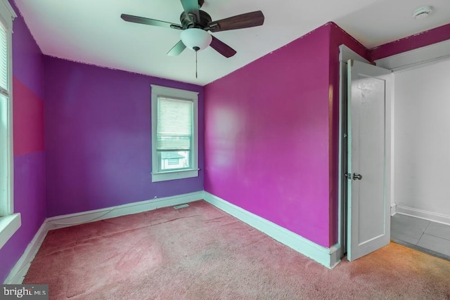 carpeted empty room featuring ceiling fan