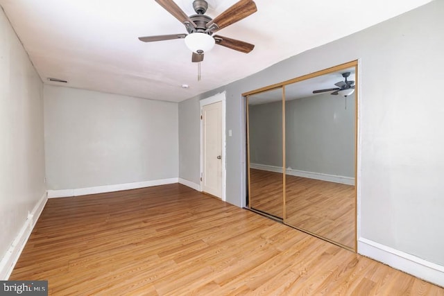 unfurnished bedroom with a closet, light hardwood / wood-style floors, and ceiling fan