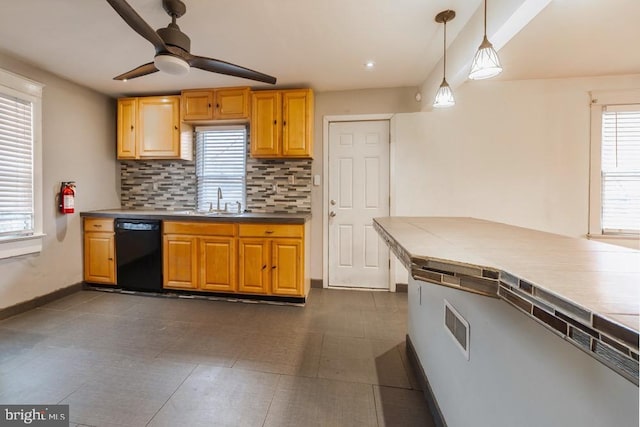 kitchen featuring backsplash, ceiling fan, a healthy amount of sunlight, decorative light fixtures, and dishwasher