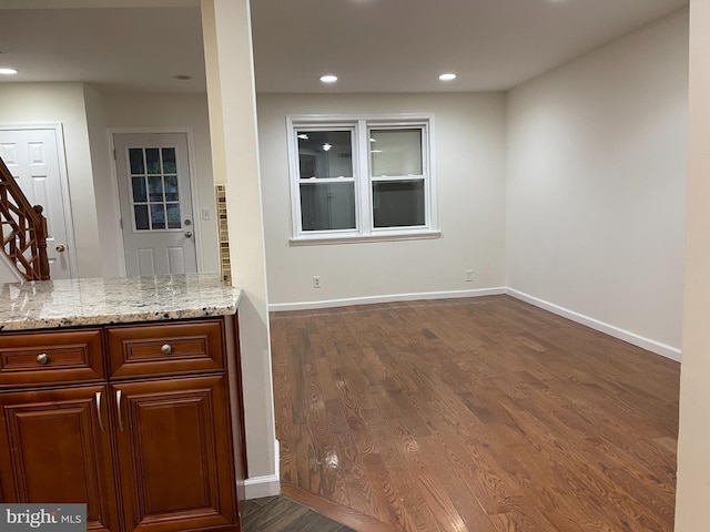 kitchen featuring light stone countertops and dark hardwood / wood-style floors