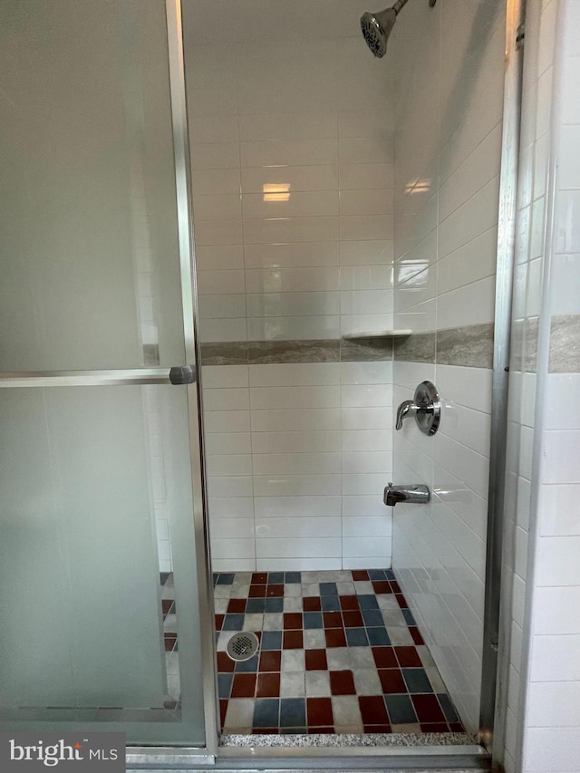 bathroom with a shower with door